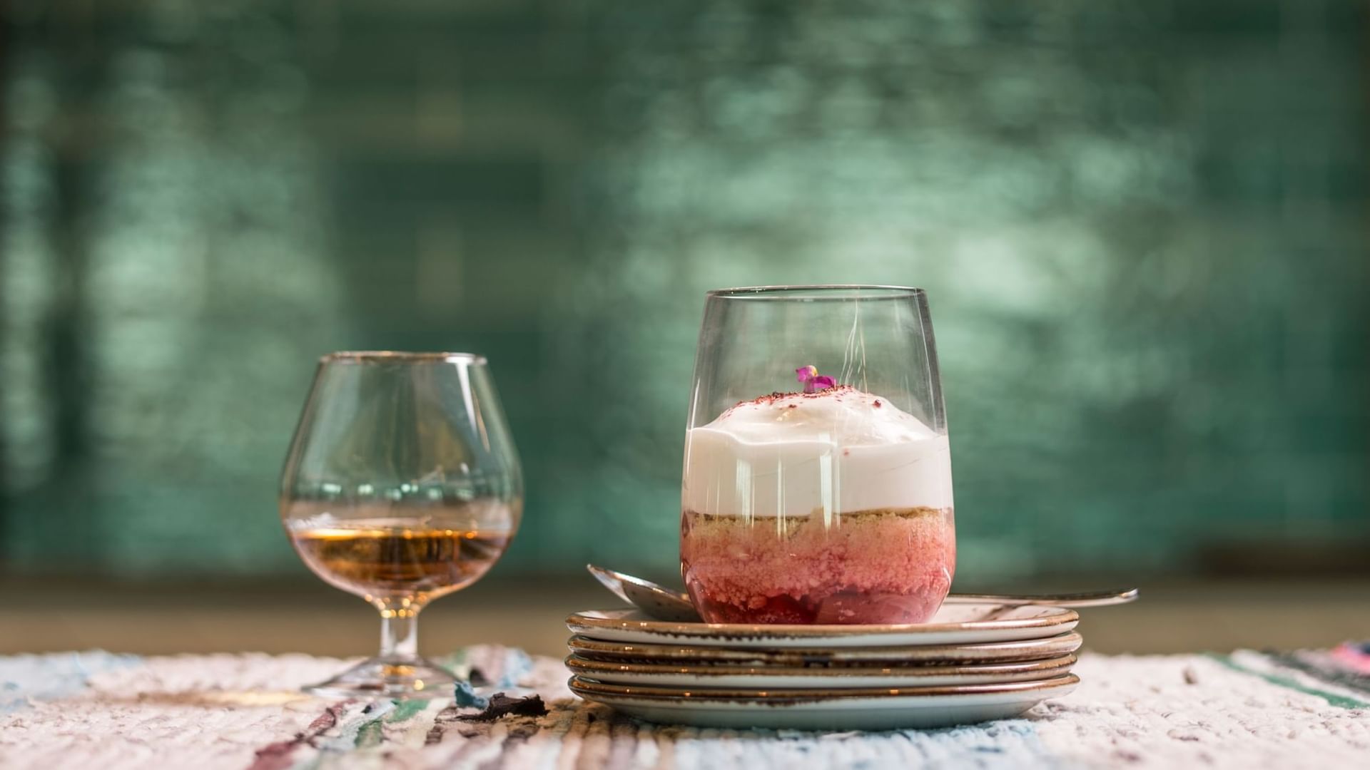 Closeup of cake jar & wine glass on a table at Novotel Barossa