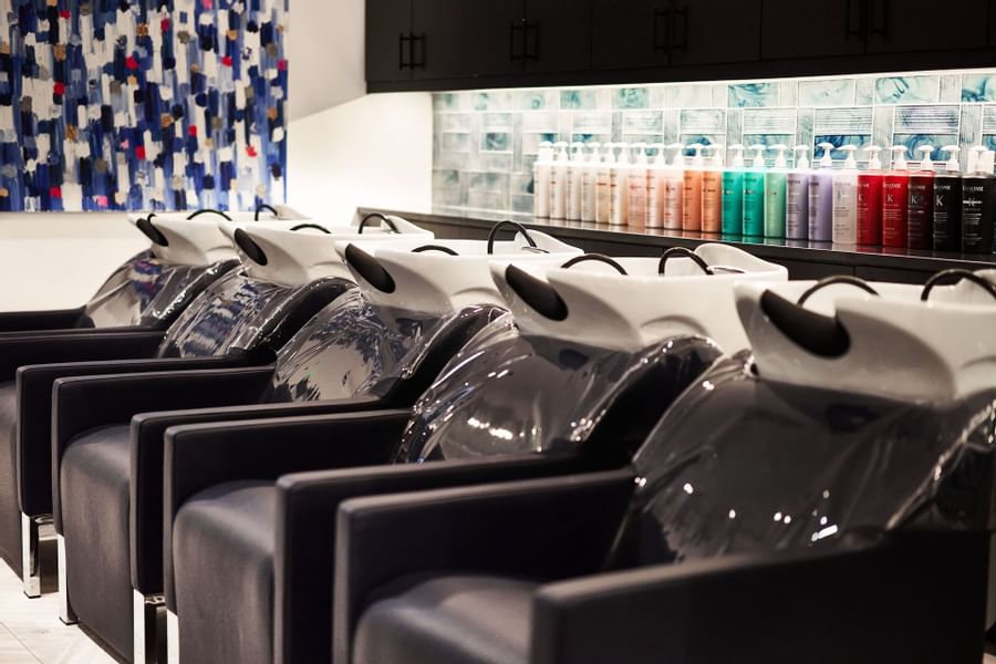 A row of hariwash chairs at the salon at Brazilian Court 