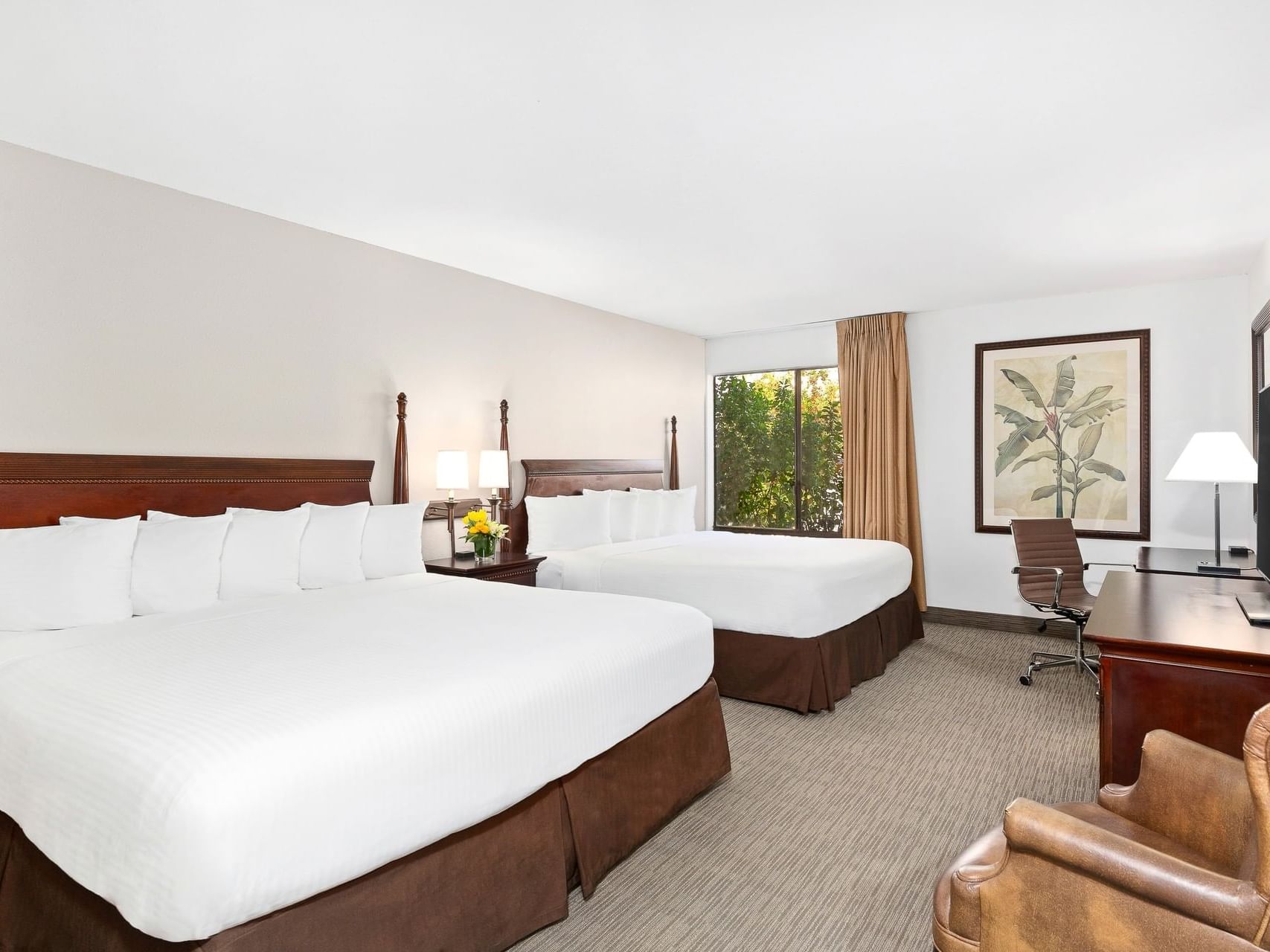 Interior of Deluxe 2 King room with twin beds at Anaheim Hotel