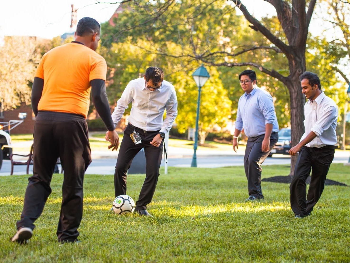4 men playing football at Kellogg Conference Center