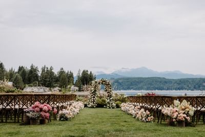 Wedding arrangements with floral décor in Waterfront Lawn at Alderbrook Resort & Spa