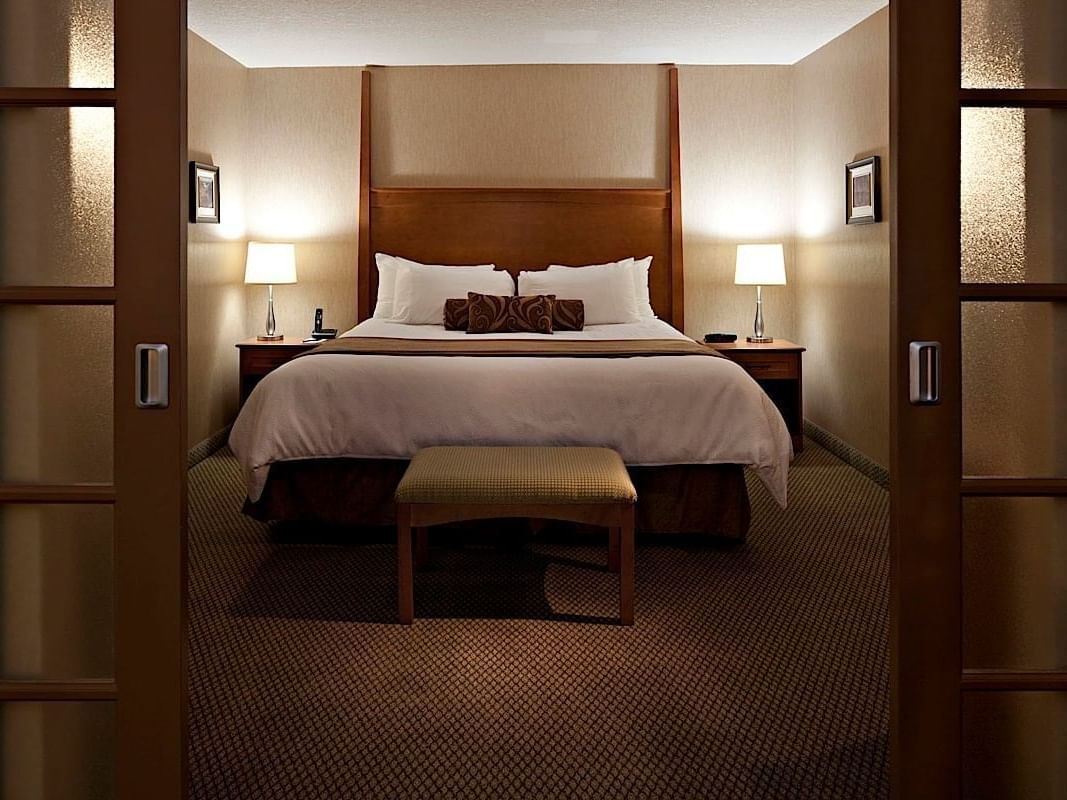 Bed & 2 nightstands in Executive Suite at Carriage House Hotel