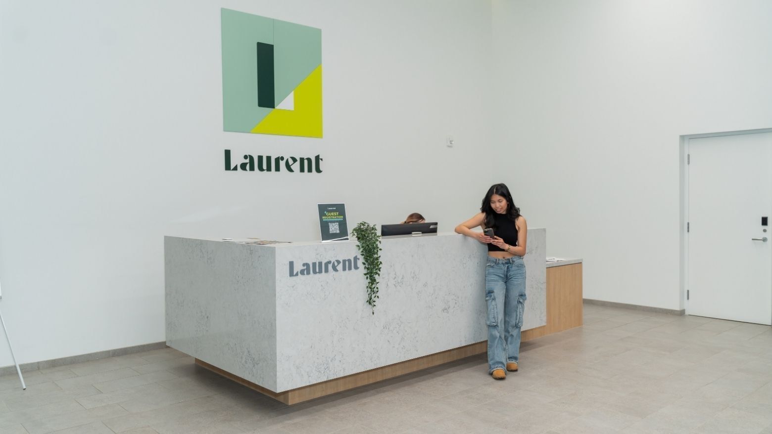Resident standing at the front desk inside Laurent.