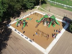 Aerial view of the vibrant playground filled with children at Cole Park near Off Shore Resort