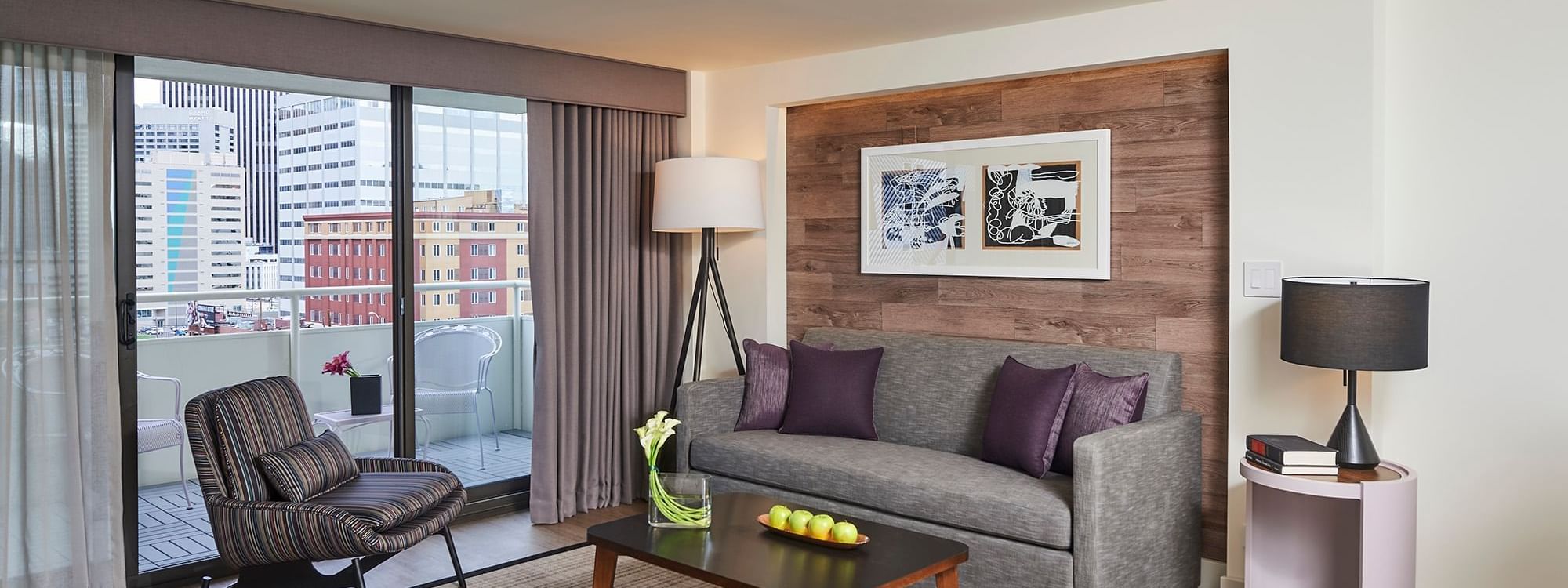 Living area with balcony view in Suite at Warwick Denver