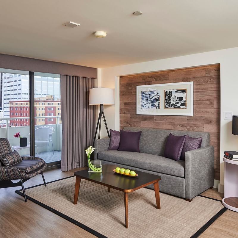 Living area with balcony view in Suite at Warwick Denver