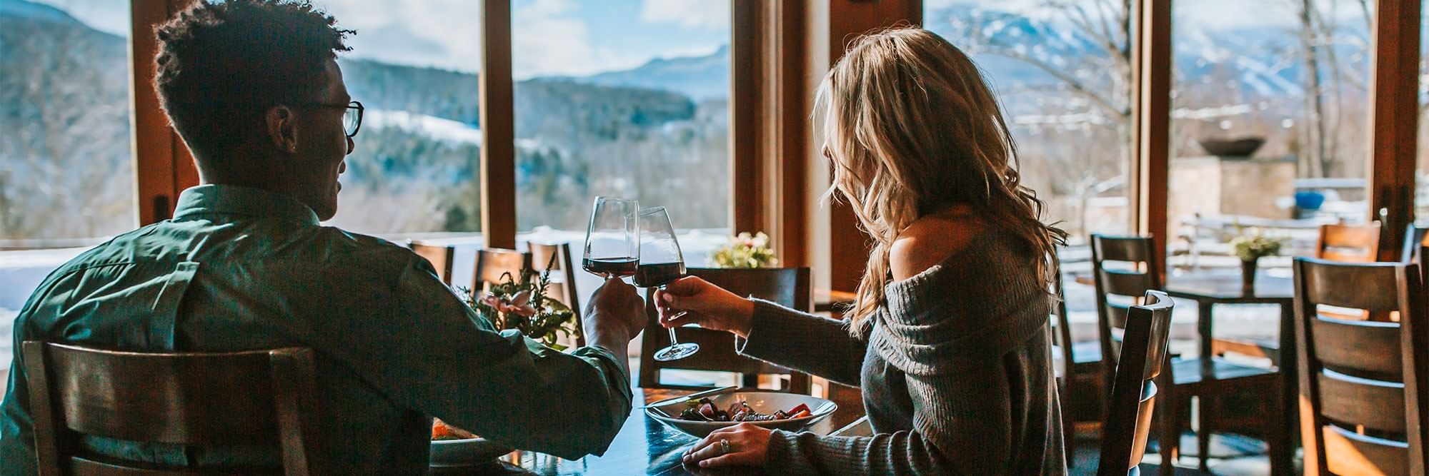 Man and woman enjoying wine in Flannel restaurant at Topnotch Resort.