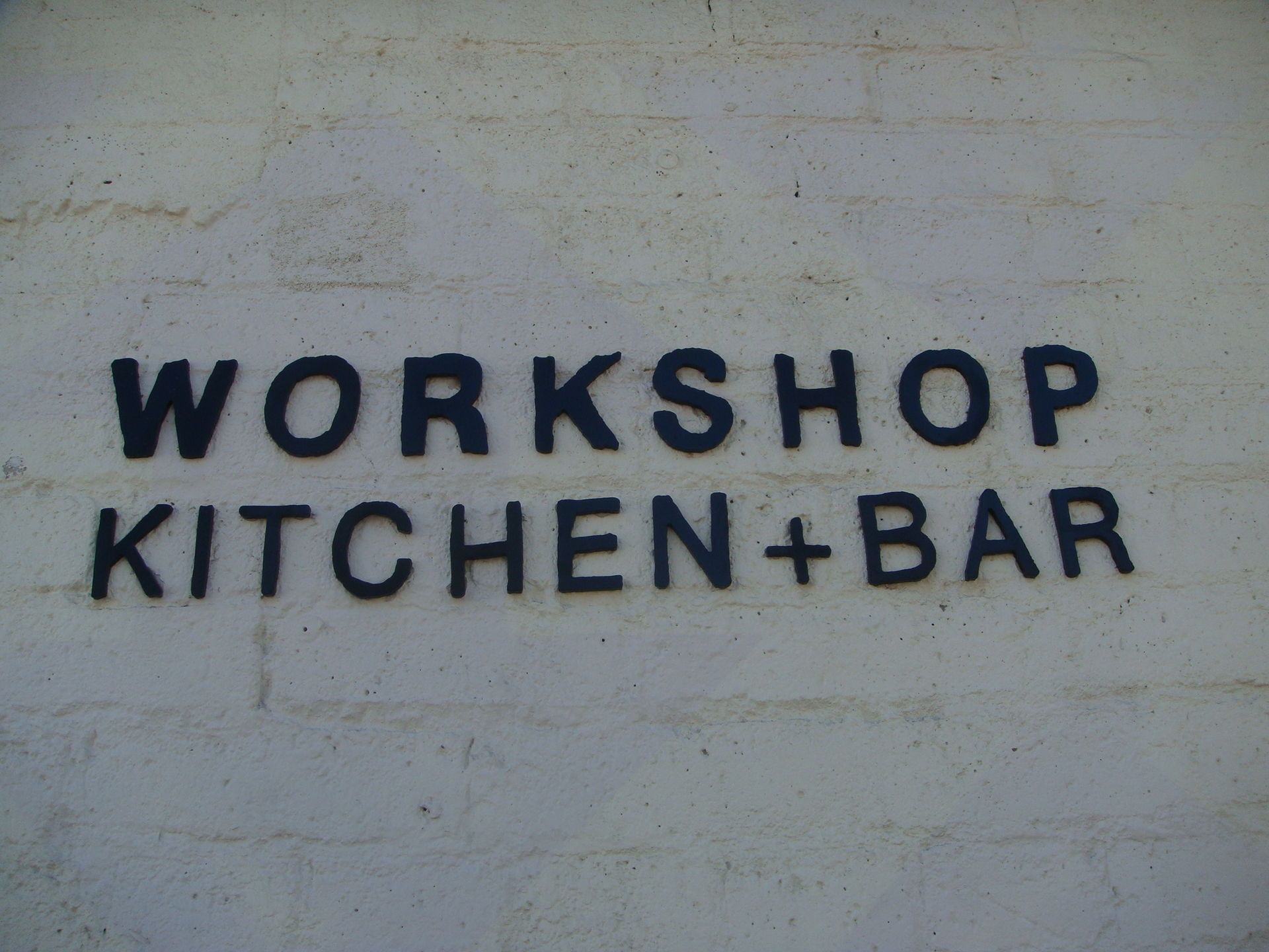 Entrance sign of Workshop Kitchen & Bar at 7 Spring Inn & Suite