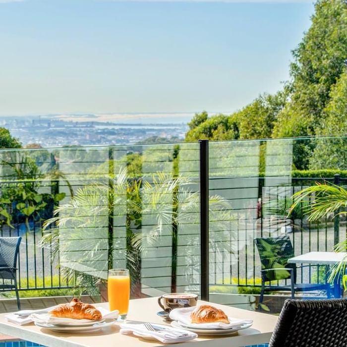 Breakfast served on a table outdoors overlooking the distant city view at Mercure Charlestown