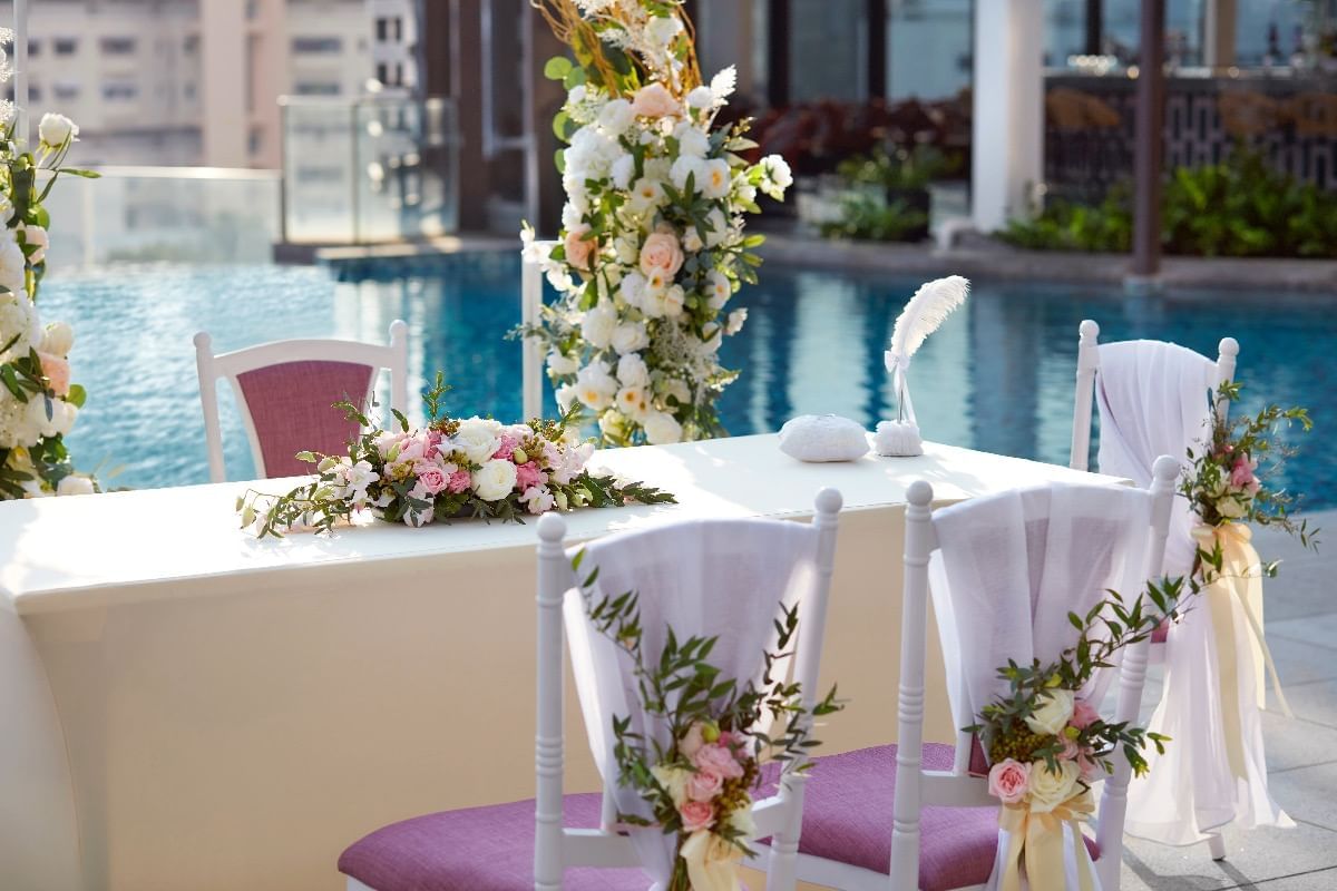 Charming wedding seating arrangement by pool deck at Momentus Hotel Alexandra