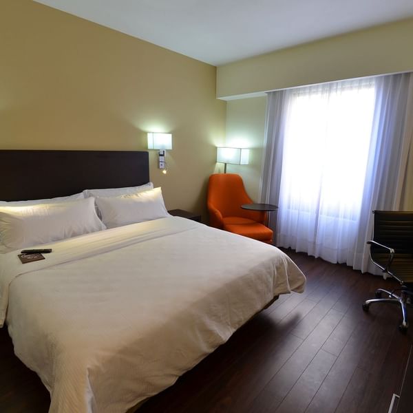 King bed with working desk In Superior Room at Fiesta Inn