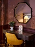 Executive King room with forest-themed wallpaper, elegant bedside lamps, and octagonal mirror at The Capital Hotel, London.