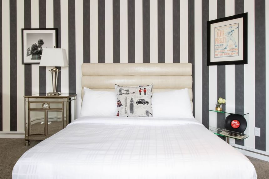 queen bed in front with two glass end tables, james dean 