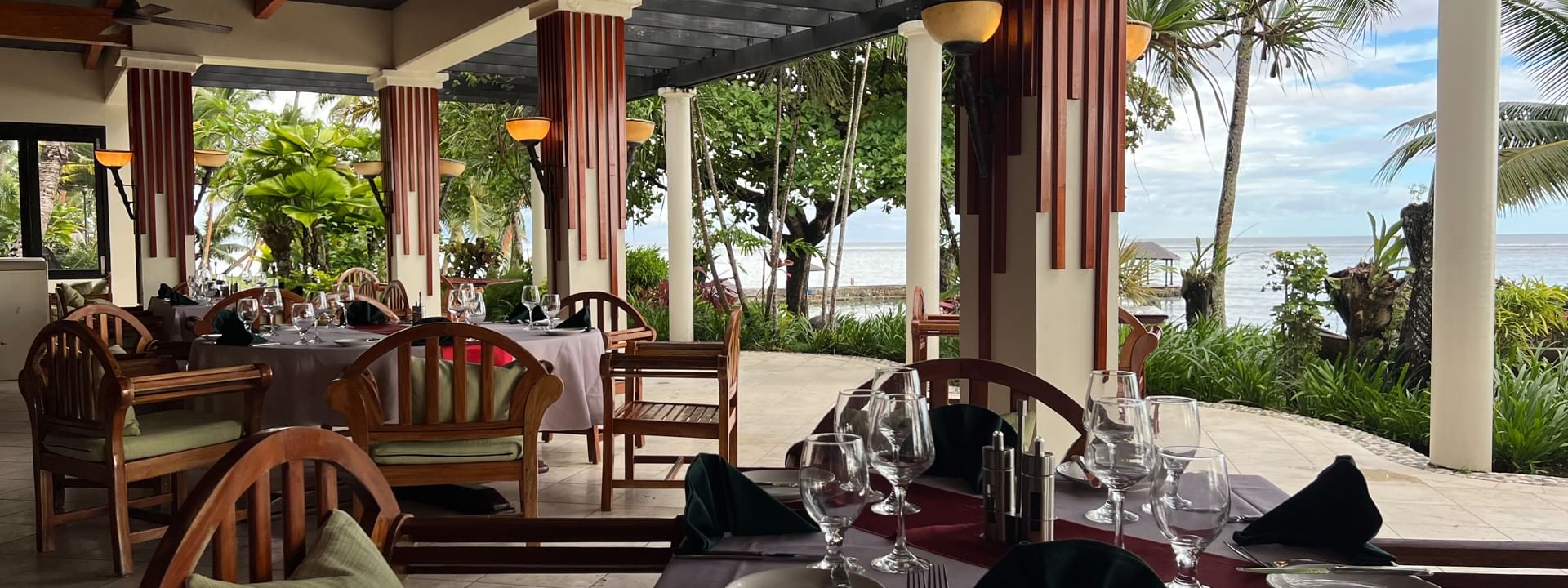 Outdoor dining area with ocean view at Pappagallo in Korolevu at Warwick Fiji Resort and Spa