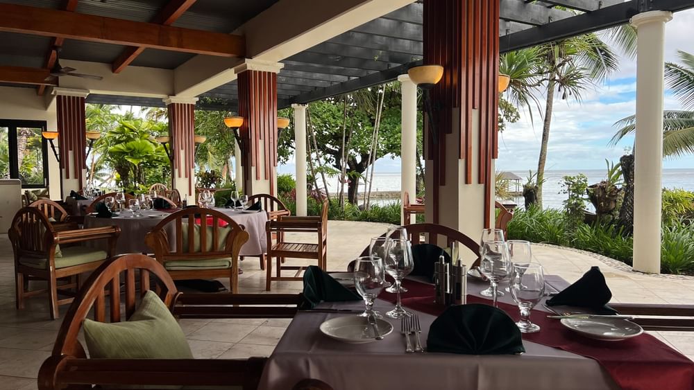 Outdoor dining area with ocean view at Pappagallo in Korolevu at Warwick Fiji Resort and Spa.