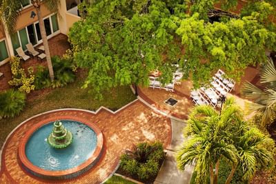Outdoor wedding setup near fountain.
