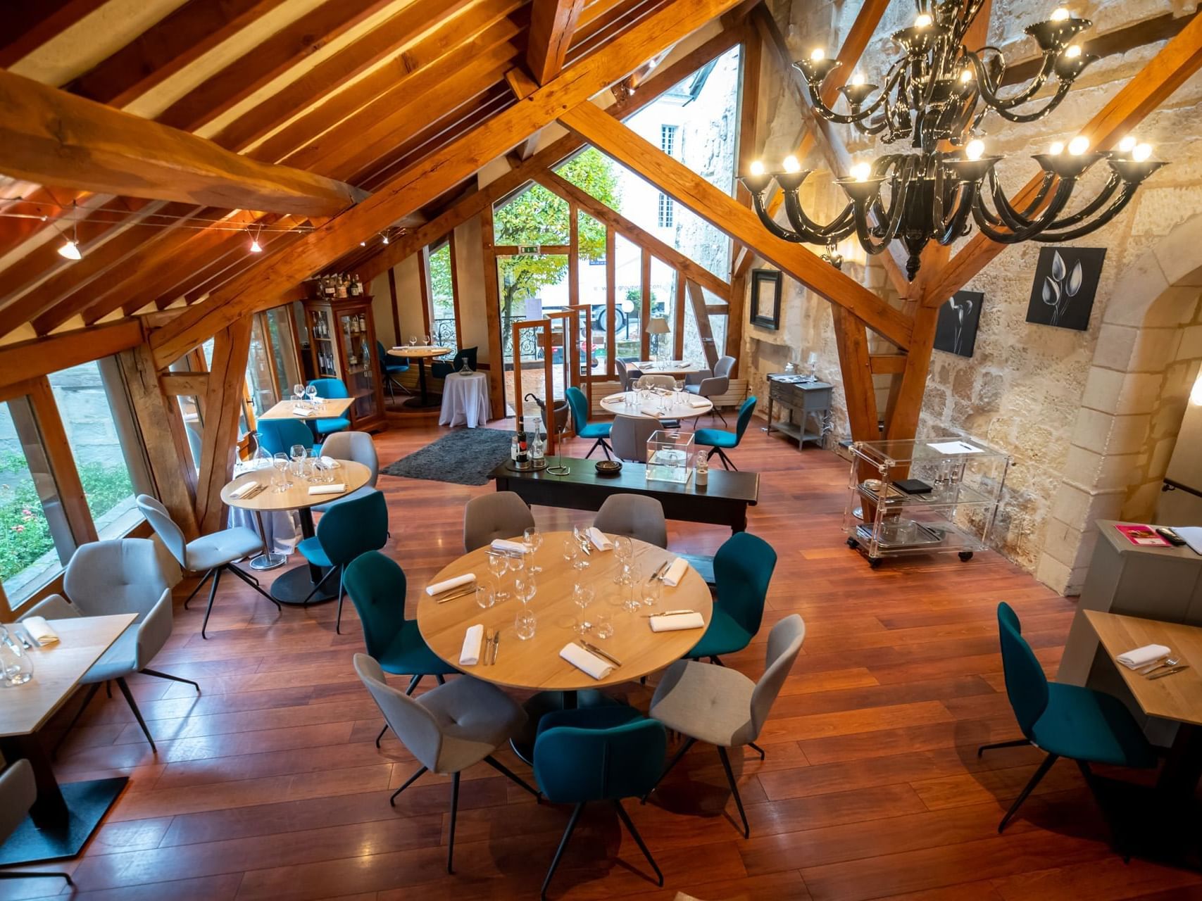 Chairs & tables with outside view at The Originals Hotels