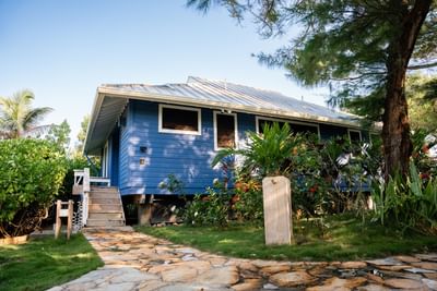 Two Bedroom Oceanfront Villa with a stone path and green plants at Barefoot Cay Resort & Marina