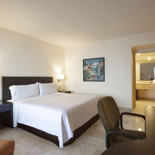 King bed with working desk in Superior Room at Fiesta Inn
