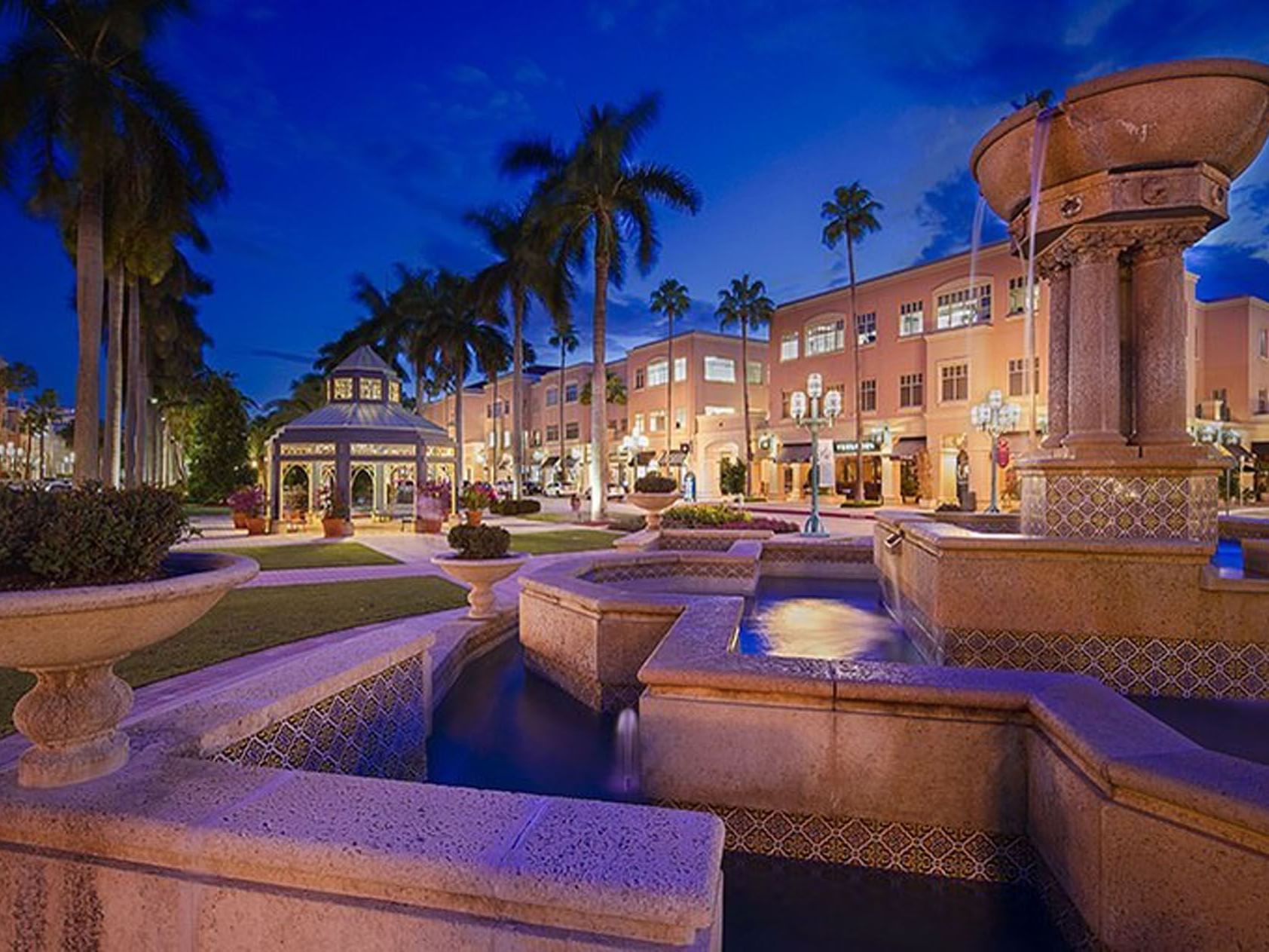 Landscape view of the fountain in Mizner Park at night near Ocean Lodge Boca Raton