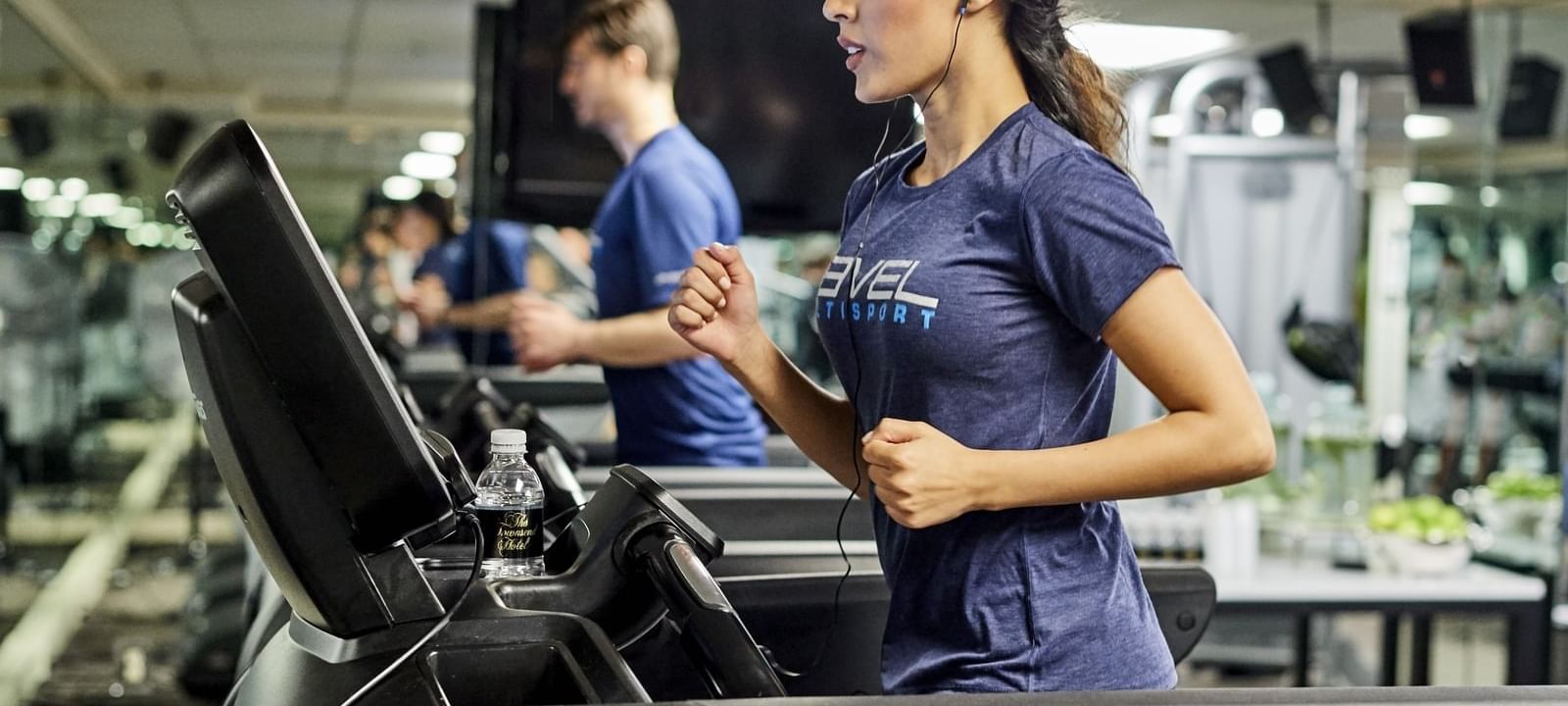 a woman running on a treadmill