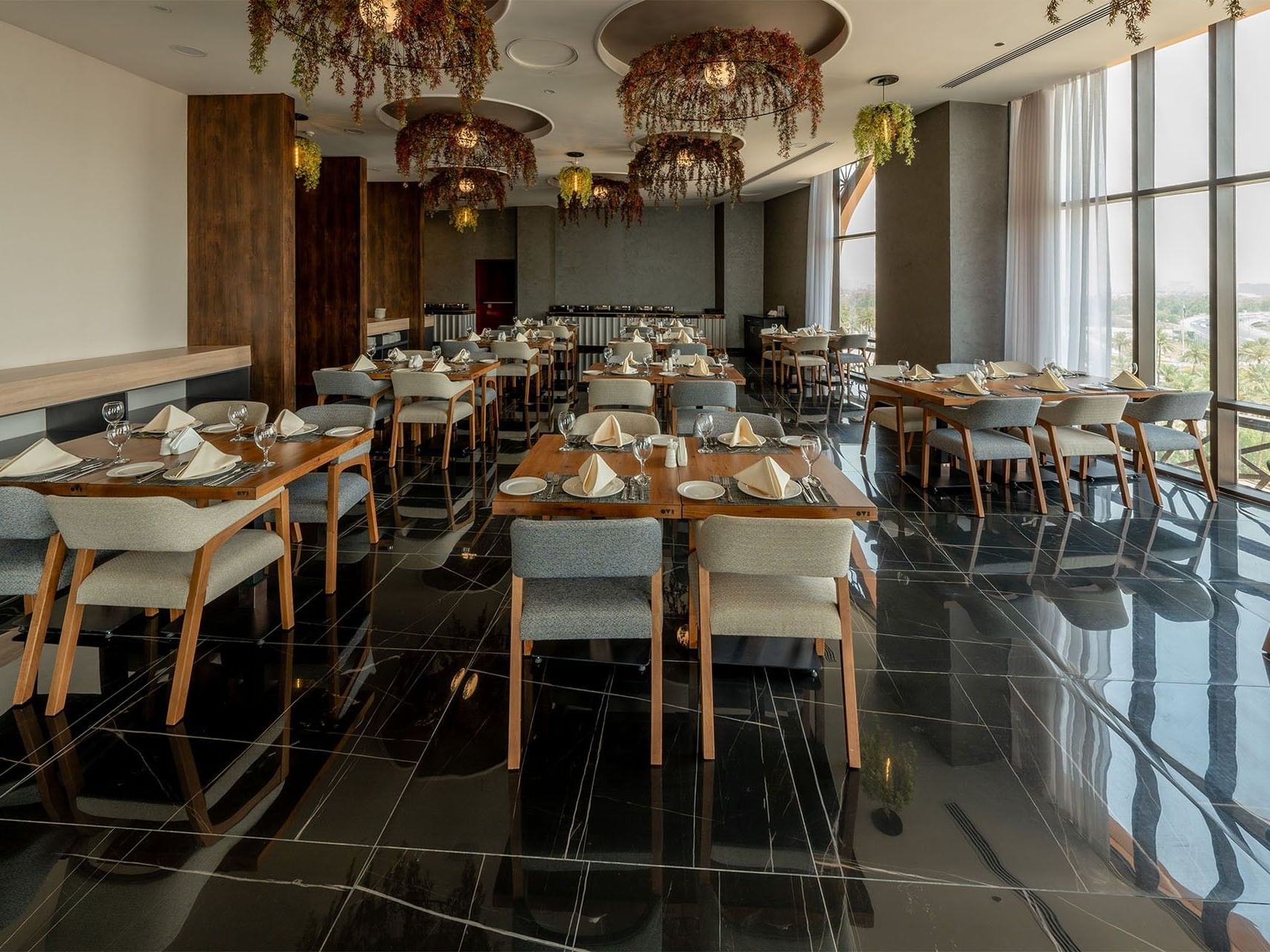 Dining room with tables and chairs at World Heart Hotel Baghdad.