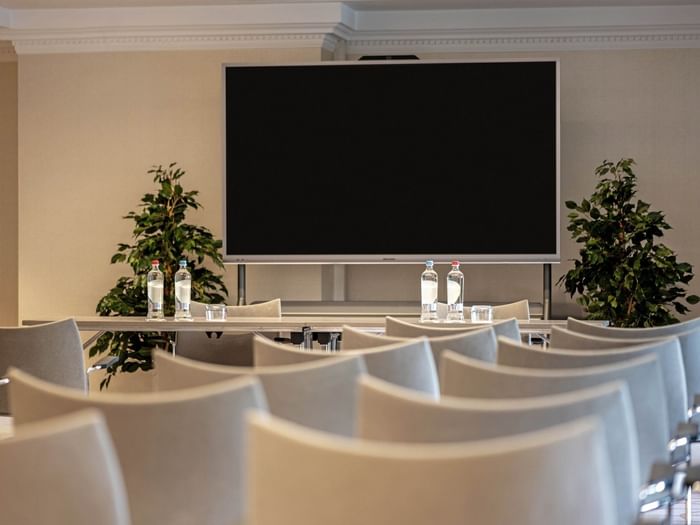 Barsey III room with theater seating facing a large screen at Hotel Barsey by Warwick