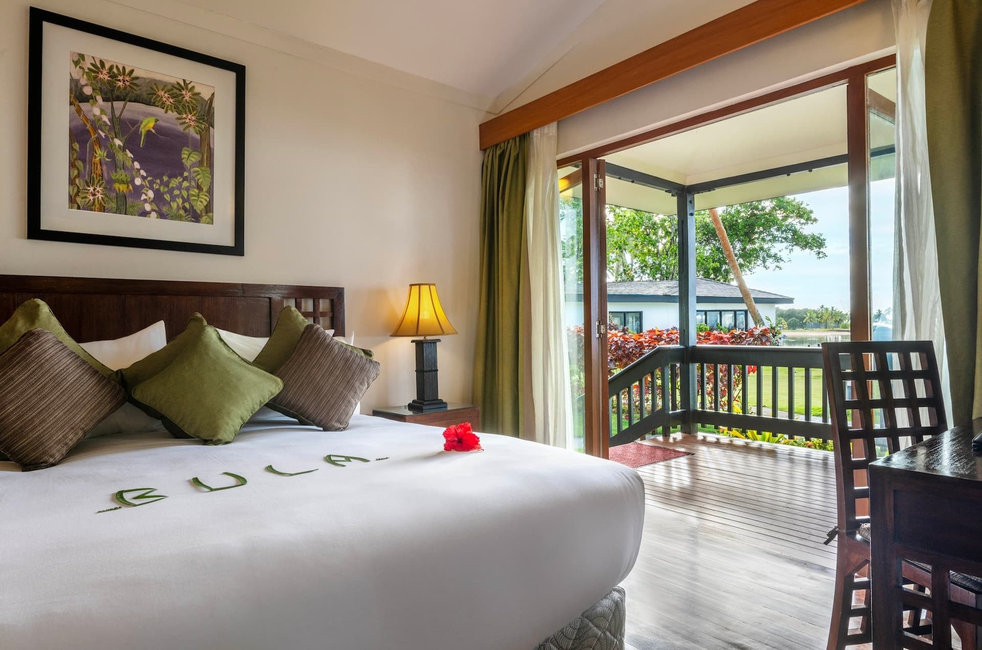 Bedroom with balcony and garden view at The Naviti Resort Fiji Coral Coast