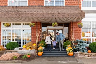 Family with their daughter arriving at Rodd Royalty, a top choice for places to stay in Charlottetown, PEI
