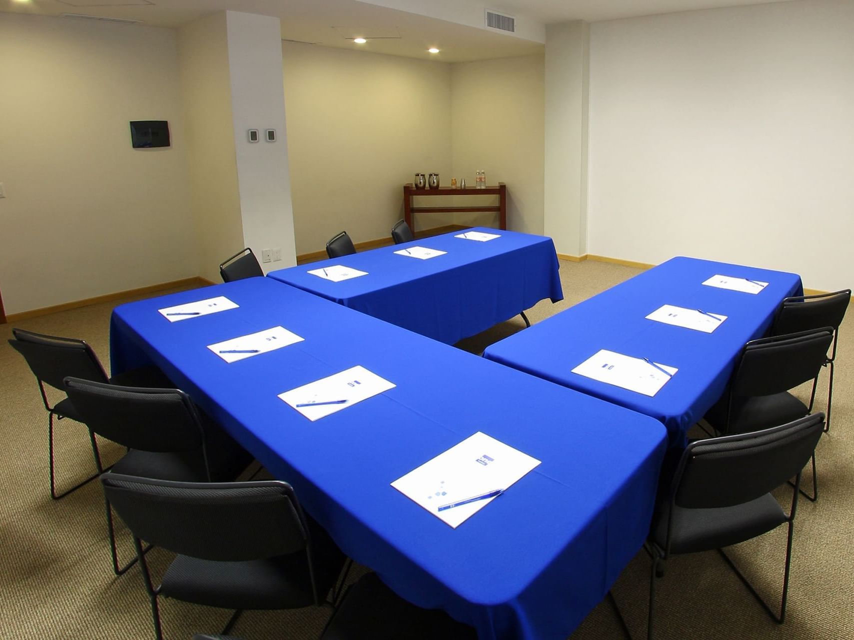 U-shaped table arrangements in a meeting room at One Hotels