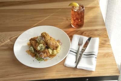 Chicken appetizer with Singapore Sling cocktail