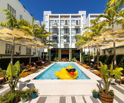 An outdoor pool with a giant yellow rubber duck at Fairwind Hotel Miami