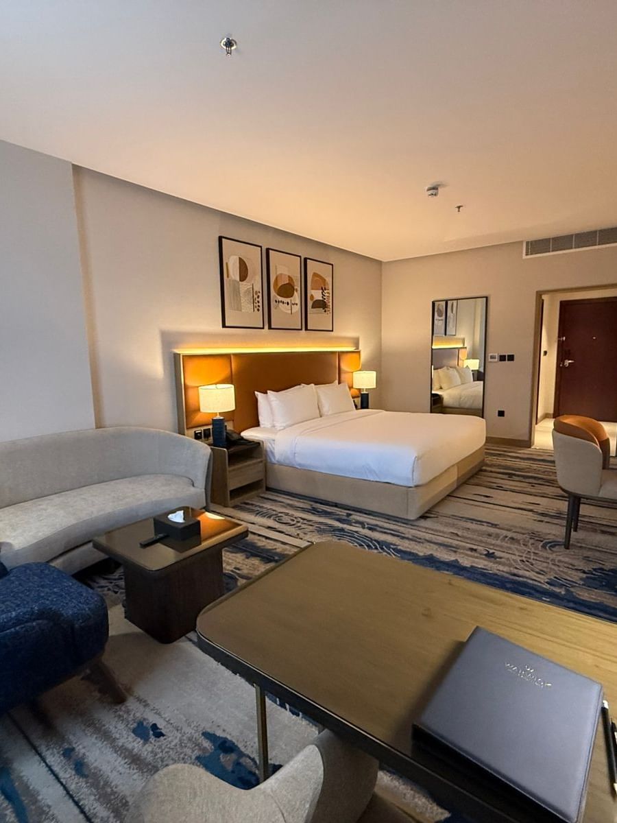 Bed beside the couch and work desks in Superior Room at Warwick Jeddah Hotel & Spa