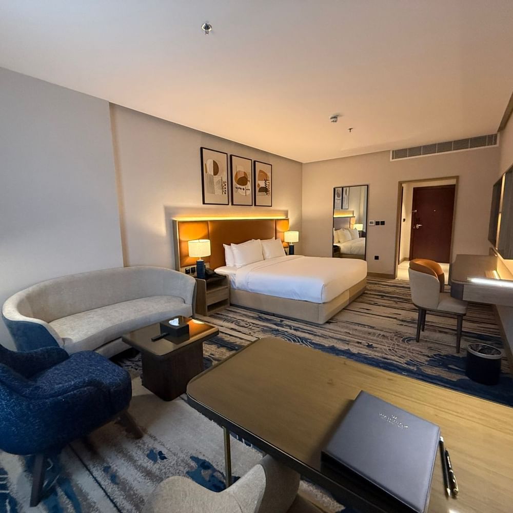 Bed beside the couch and work desks in Superior Room at Warwick Jeddah Hotel & Spa