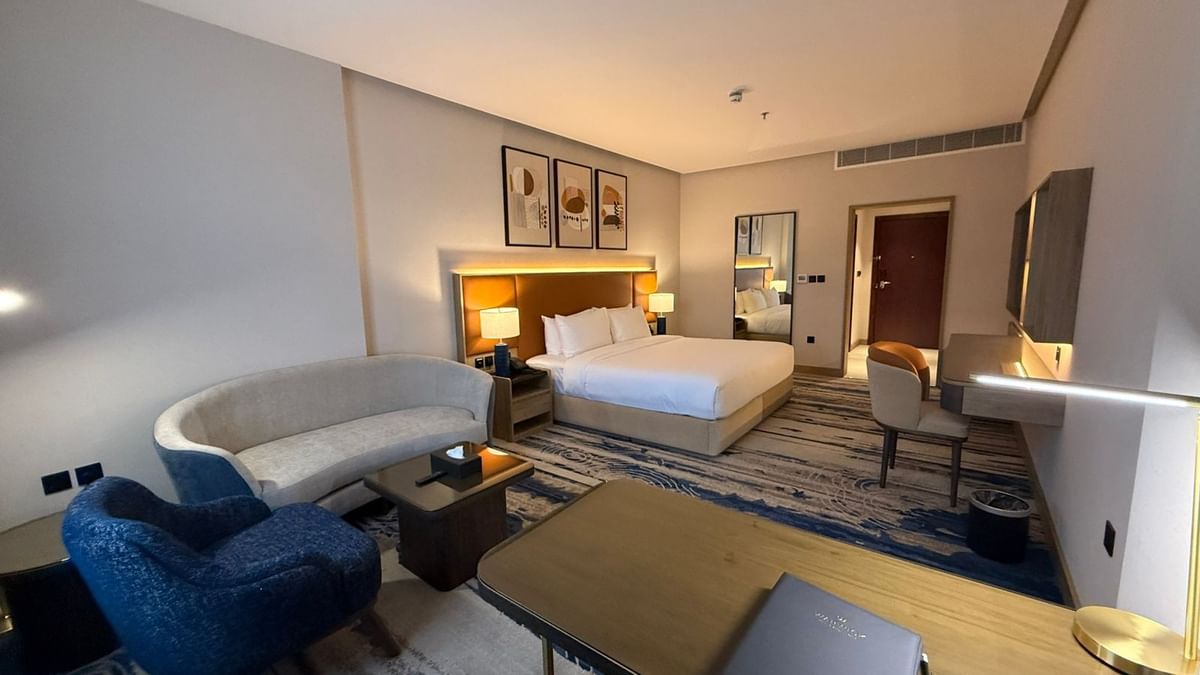 Bed beside the couch and work desks in Superior Room at Warwick Jeddah Hotel & Spa