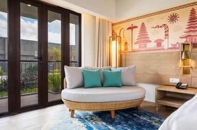 Living area with outside view in Deluxe Room at Eastin Ashta Resort Canggu