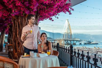 Couple having dinner near the beach at Playa Los Arcos