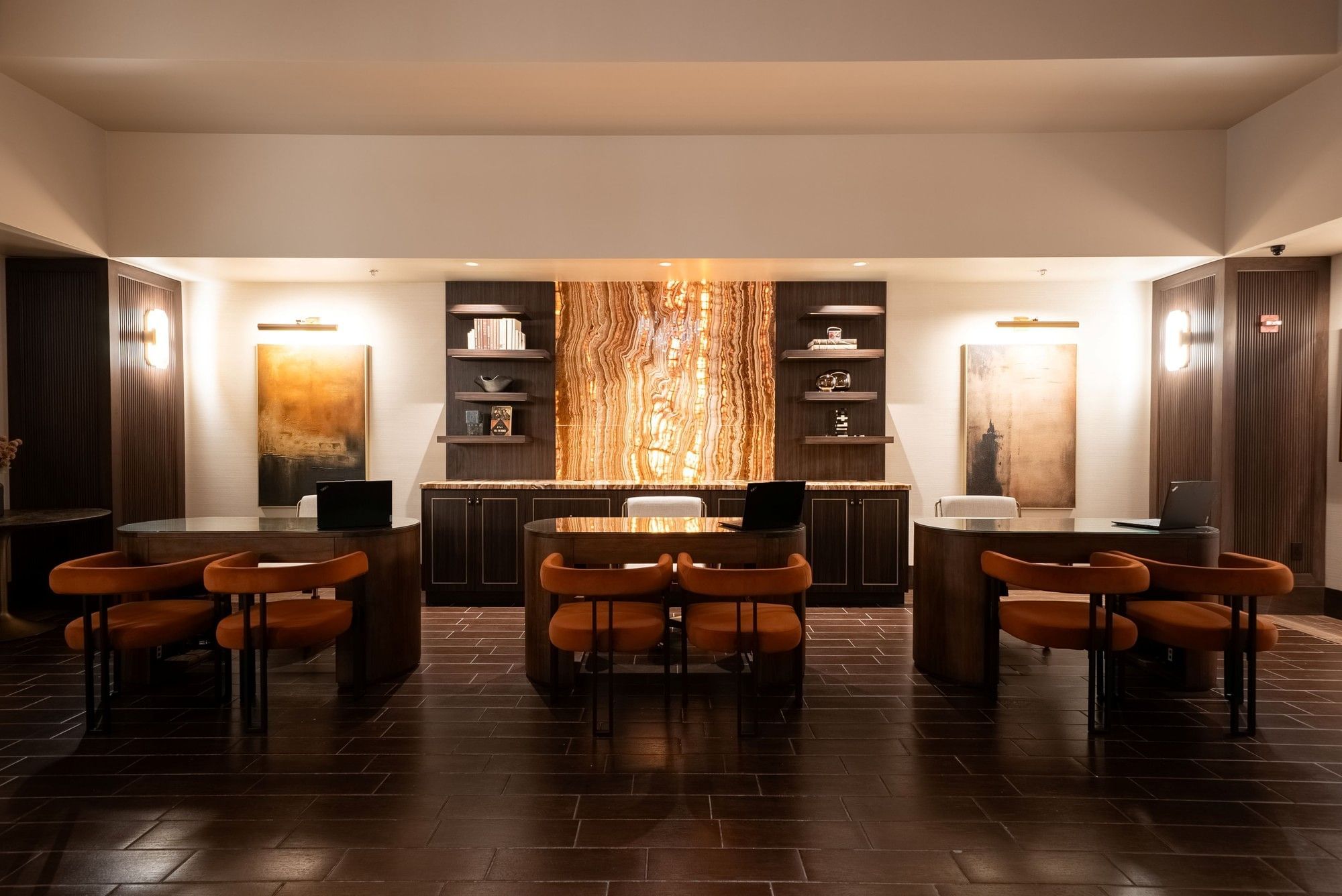 Front desk reception area with wooden check-in desks and illuminated stone feature wall inside Eureka Casino Resort