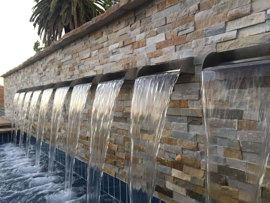 Close-up of an outdoor wall fountain at The Nest Palo Alto
