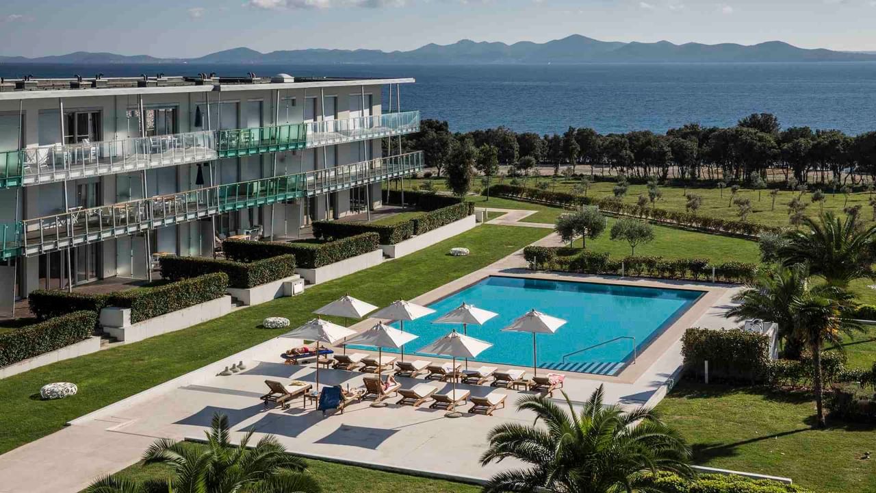 Aerial view of an outdoor pool & sunbeds, Falkensteiner Hotels