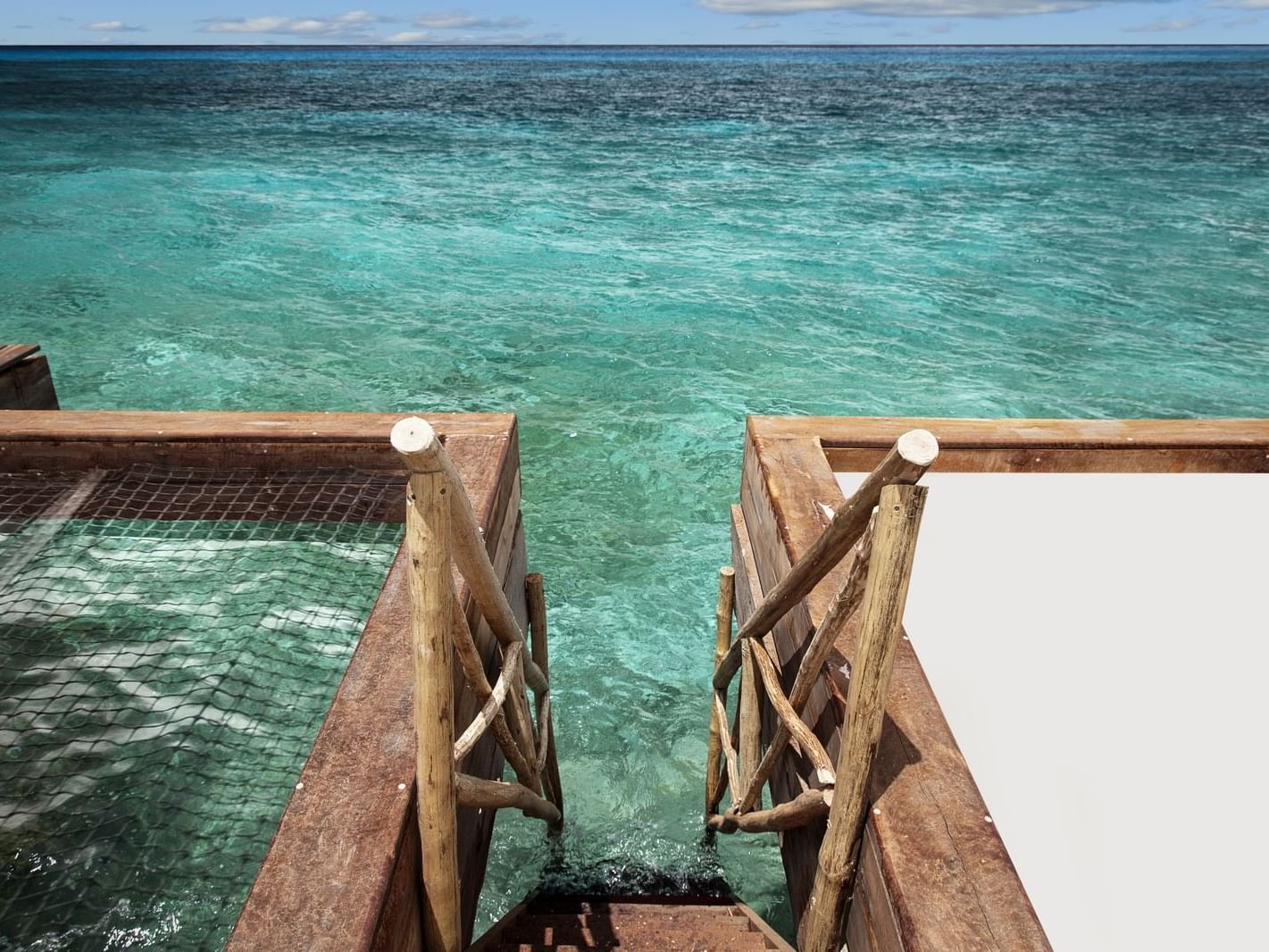 Staircase to enter ocean water in a pool in the Cozumel