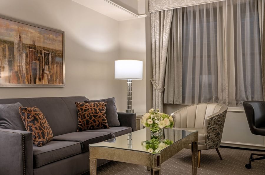 Living room with couch, table, armchair, and modern decor at Warwick New York.
