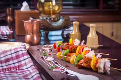 Meet skewer served on a wooden plate at Ajman Hotel