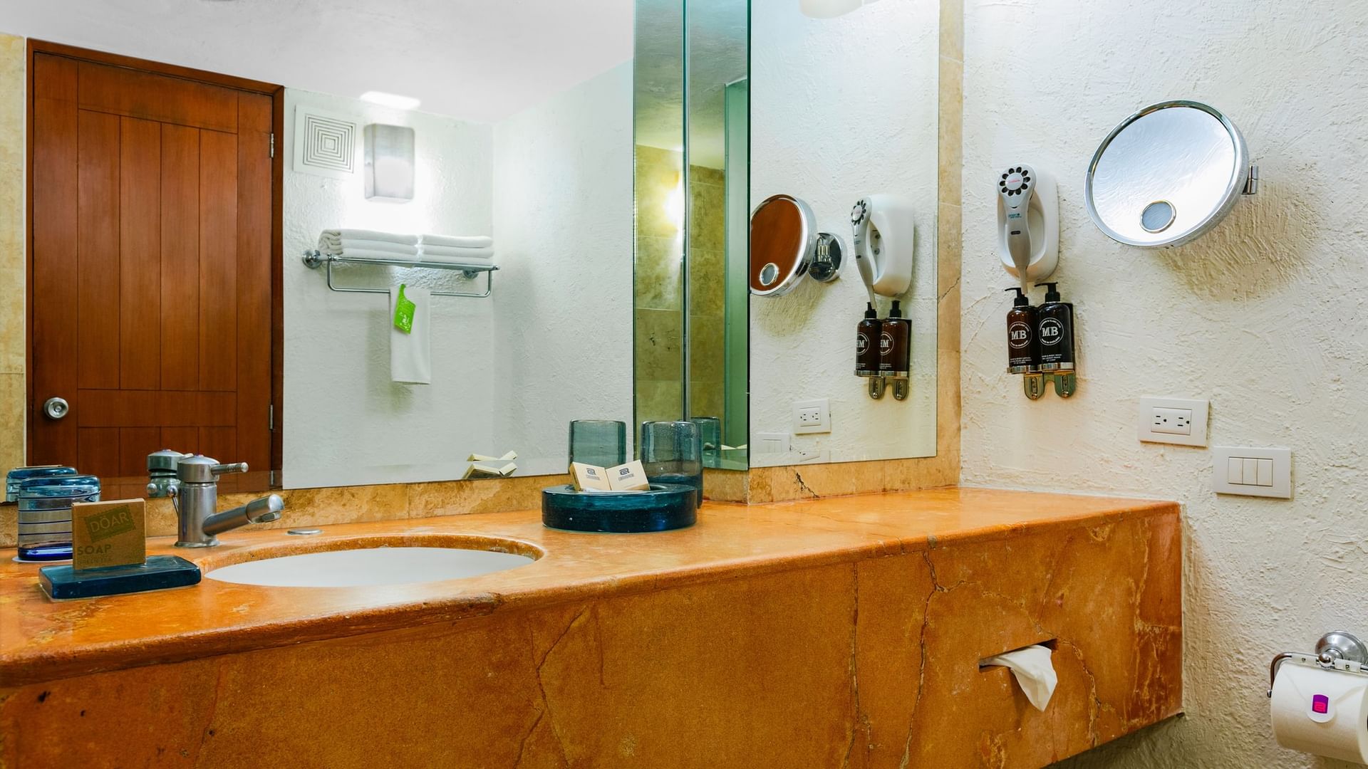 Elegant bathroom with large mirror and modern fixtures in King Deluxe room at Camino Real Guadalajara in Zapopan