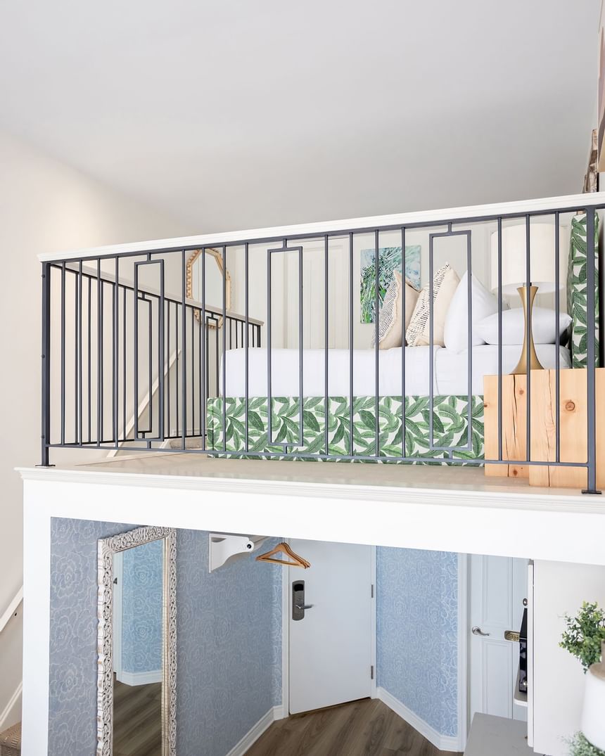 Comfy bed, nightstand & dressing area in Superior Loft at Retro Suites Hotel