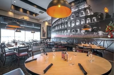 Dining tables set up in Pacini restaurant near Acclaim Hotel Calgary