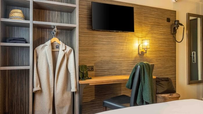 Coat & towel in a room in Angers South at The Originals Hotels