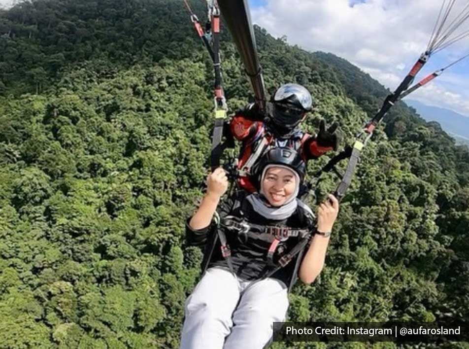 A woman was tandem paragliding at KKB Paragliding Park - Lexis Suites Penang