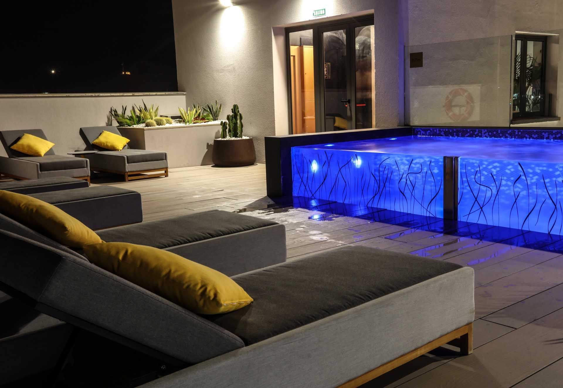 Seating area by the pool at Design Plus Group Hotels