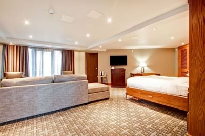 spacious room with furniture and TV at The Inn of Waterloo